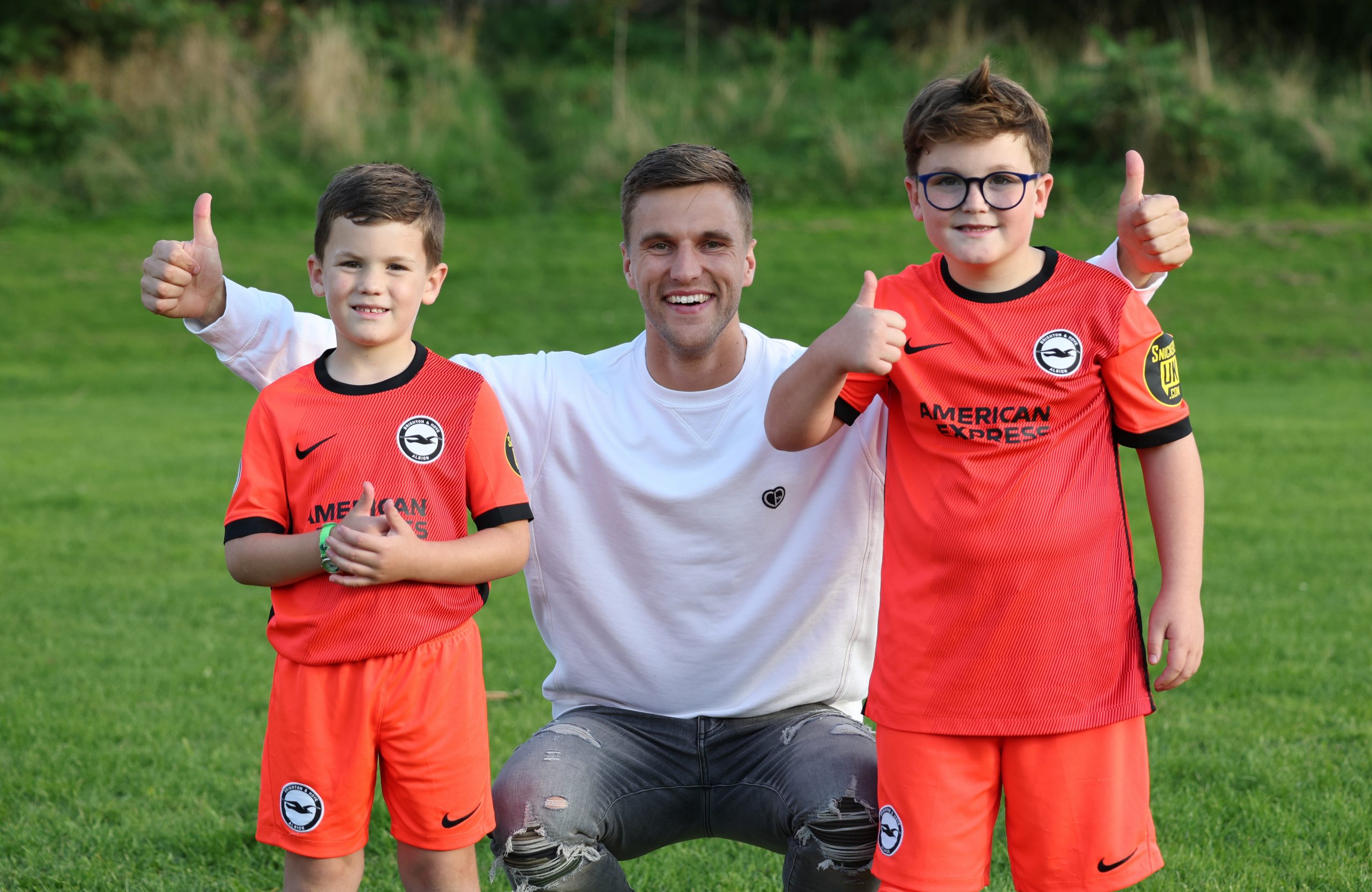 joel veltman with two boys thumbs up