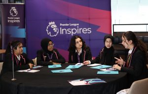 Girls discussing during a Premier League Inspires event at the Amex Stadium