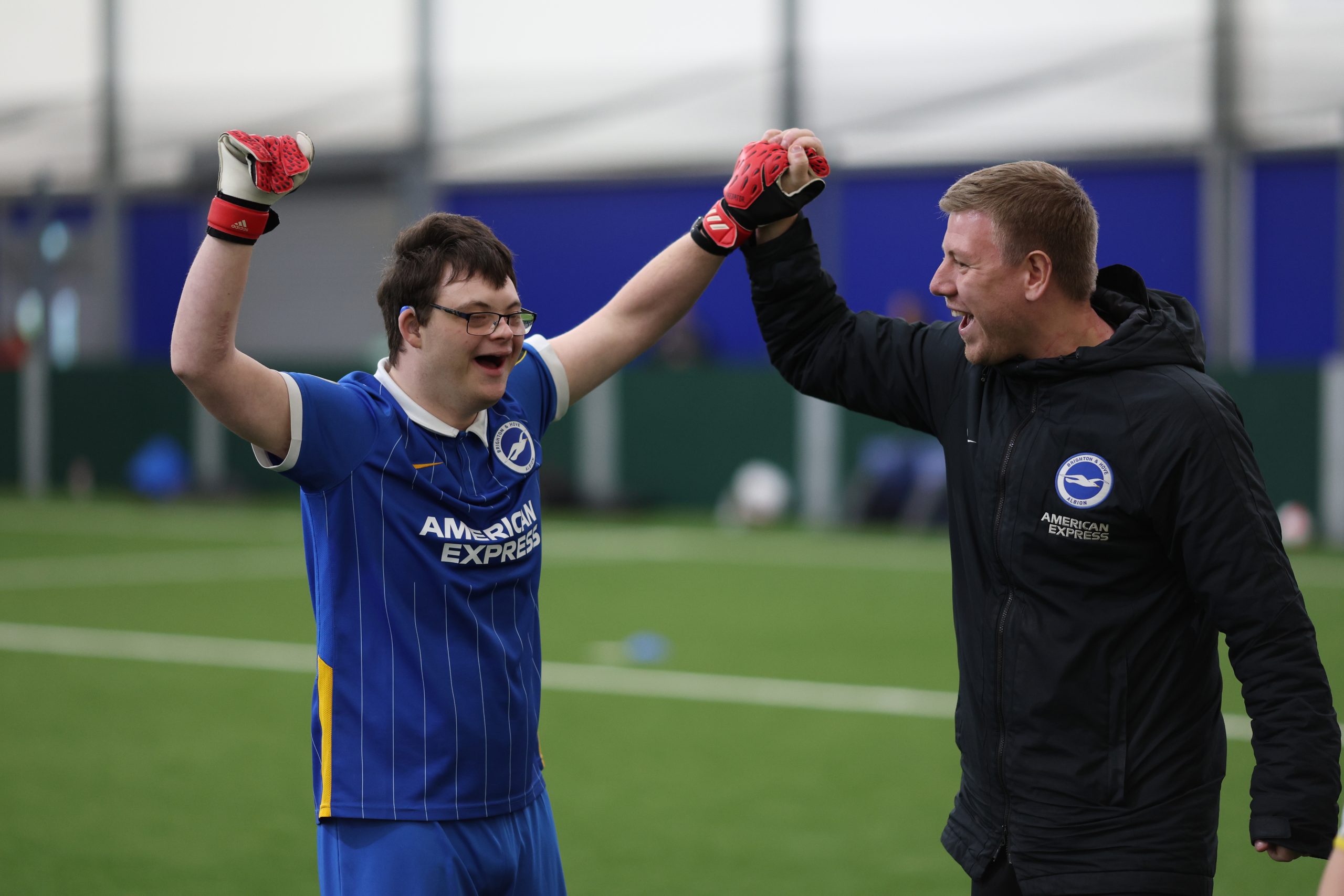 kid and coach high fiving