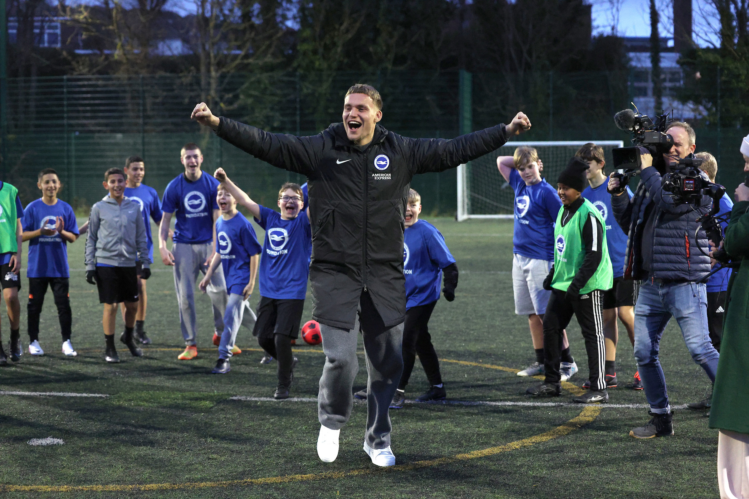 Bart Verbruggen celebrates in front of a crowd of children wearing BHAFC foundation tees.