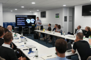 Alex Blower gives a presentation about Boys Impact to a room of Foundation staff